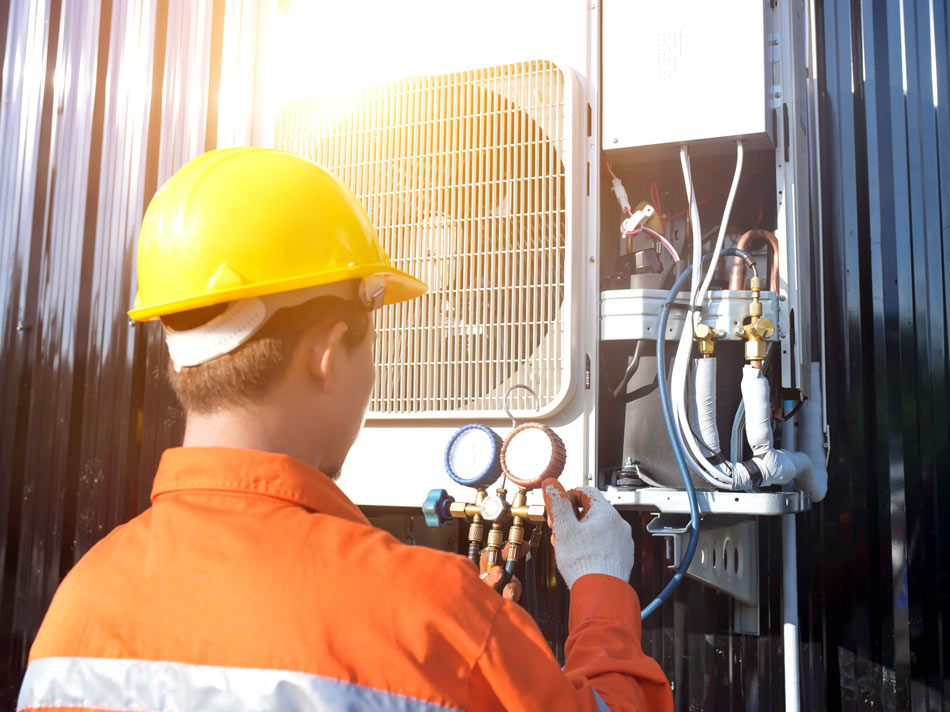 Commercial-Repair_378026278-950×712 Technician repairing a commercial HVAC system