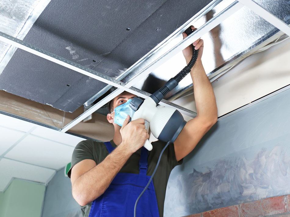 Ventilation-211322441-950×712 Technician working on ceiling ventilation